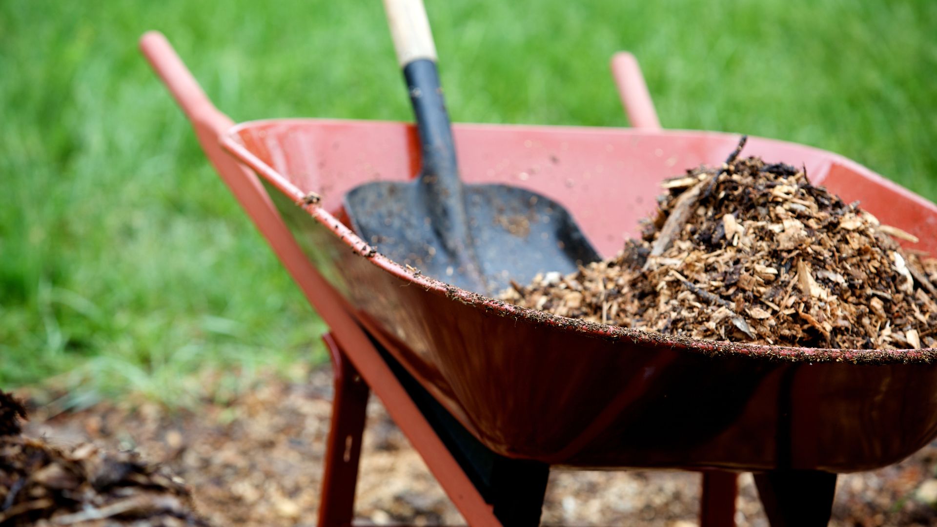 Close-up of premium bark mulch being installed in a garden bed
