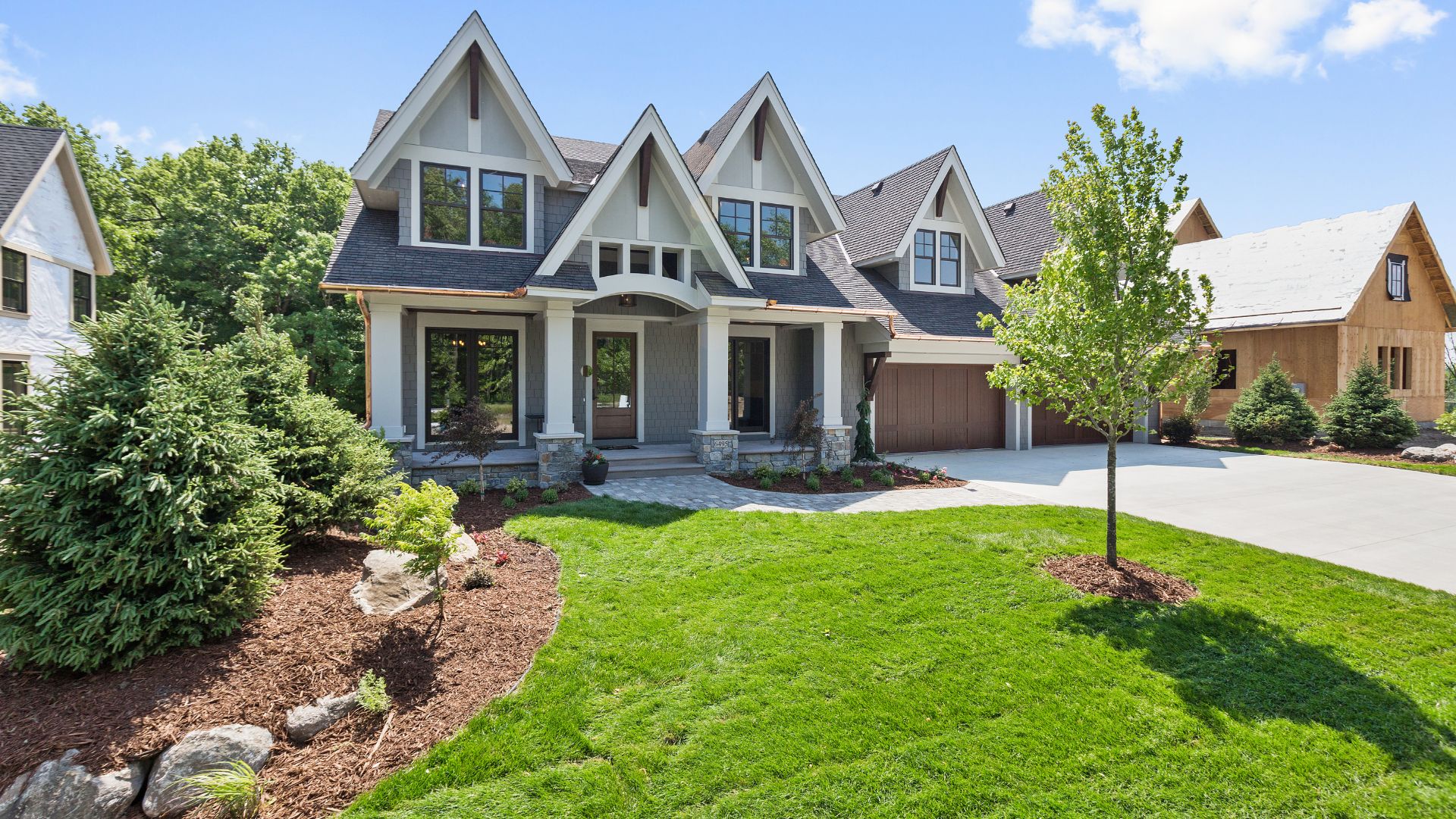 Multi-story Crofton home with landscaped grounds in the evening