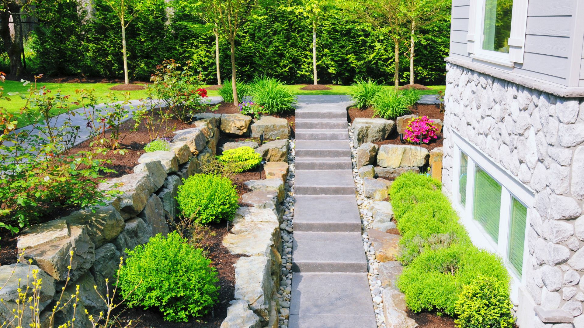 Stone steps and layered retaining walls built by hardscaping professionals