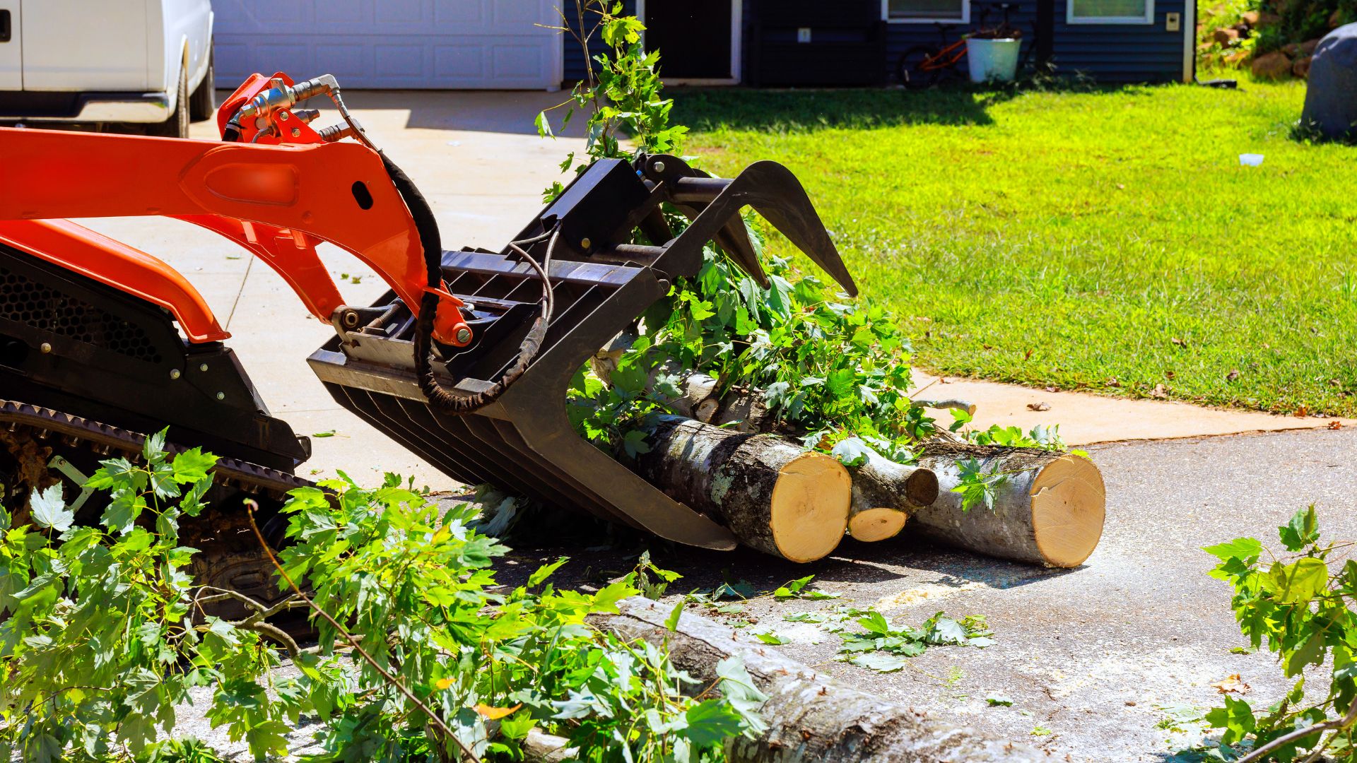 Wood chipper processing storm debris after emergency tree work